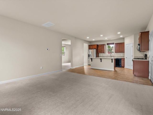 1105 Fiore Ct, Minden, NV 89423 - unfurnished living room with light carpet, recessed lighting, a sink, plenty of natural light, and arched walkways