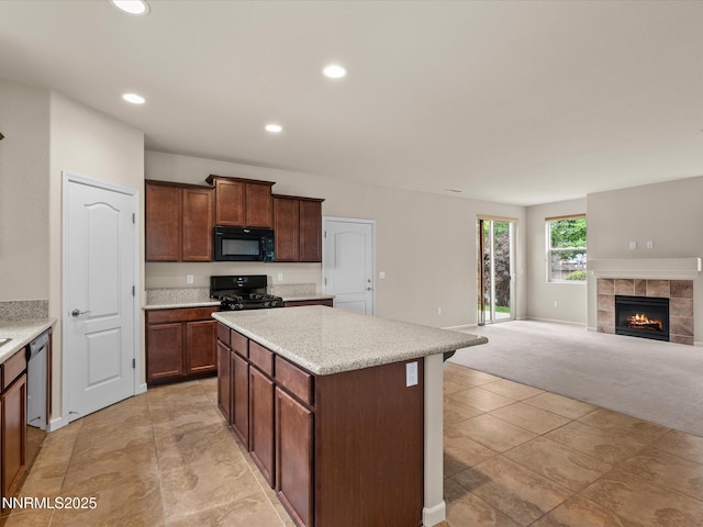 1105 Fiore Ct, Minden, NV 89423 - kitchen featuring black appliances, a center island, open floor plan, light countertops, and recessed lighting