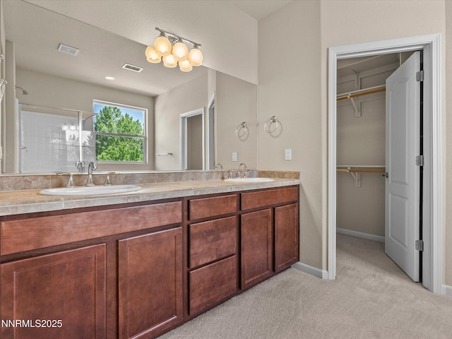 1105 Fiore Ct, Minden, NV 89423 - bathroom featuring double vanity, a shower stall, a chandelier, and baseboards