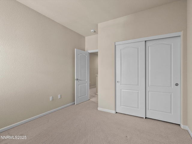 1105 Fiore Ct, Minden, NV 89423 - unfurnished bedroom with light carpet, baseboards, and a closet
