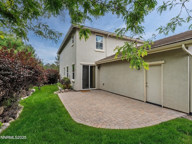 1105 Fiore Ct, Minden, NV 89423 - rear view of property featuring stucco siding, a lawn, and a patio