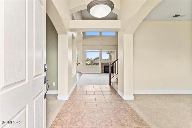 1239 Flintwood Dr, Carson City, NV 89703 - entryway featuring light carpet, arched walkways, stairs, and baseboards
