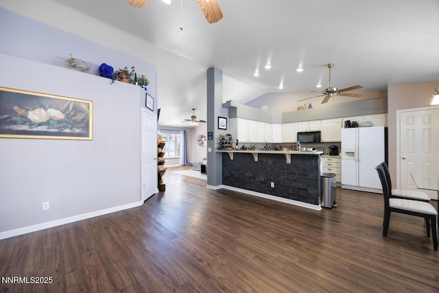 791 Noel Ln, Fallon, NV 89406 - kitchen featuring ceiling fan, white fridge with ice dispenser, black microwave, a peninsula, and high vaulted ceiling