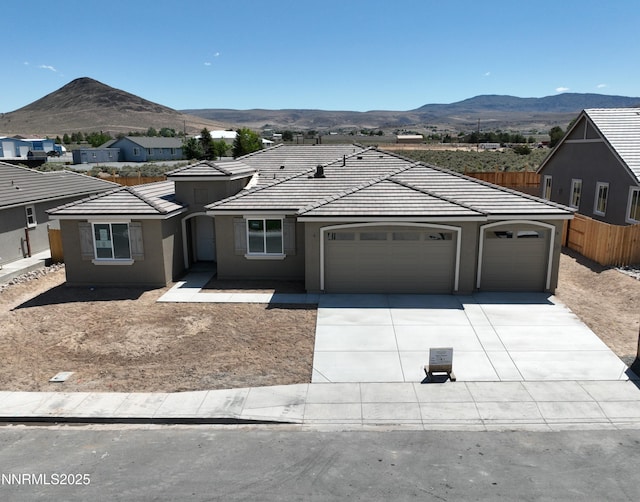 2350 Seaberry Dr, Sparks, NV 89441 - single story home featuring a garage, concrete driveway, a mountain view, stucco siding, and a tile roof