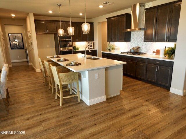 2350 Seaberry Dr, Sparks, NV 89441 - kitchen with a sink, wall chimney exhaust hood, appliances with stainless steel finishes, tasteful backsplash, and recessed lighting