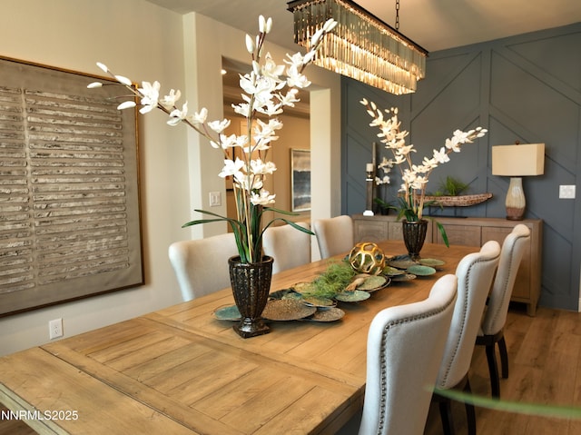 2350 Seaberry Dr, Sparks, NV 89441 - dining area with a chandelier, wood finished floors, and a decorative wall