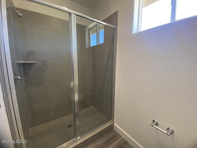 897 Agate Way, Fernley, NV 89408 - bathroom with a shower stall, baseboards, and wood finished floors