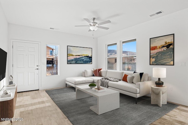 877 Agate Way, Fernley, NV 89408 - living area with light wood-style flooring, ceiling fan, and baseboards