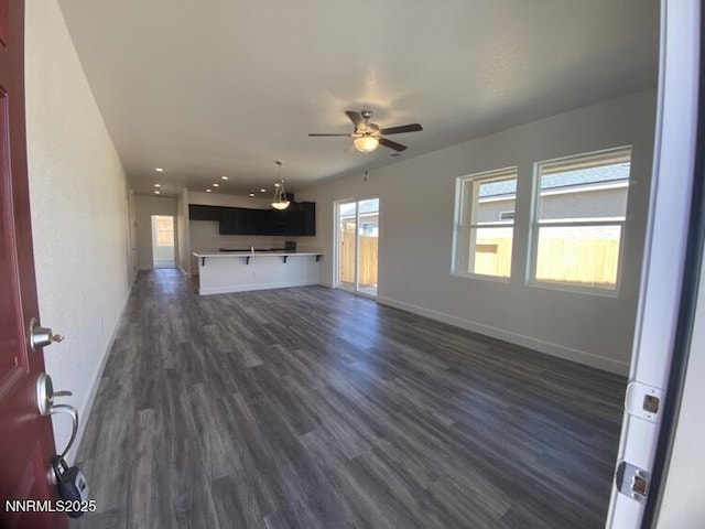 877 Agate Way, Fernley, NV 89408 - unfurnished living room featuring ceiling fan, dark wood-type flooring, baseboards, and recessed lighting
