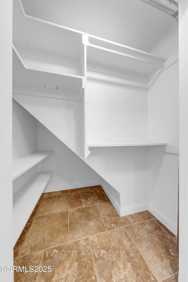 1220 Conway Ln, Reno, NV 89503 - walk in closet with stone tile flooring