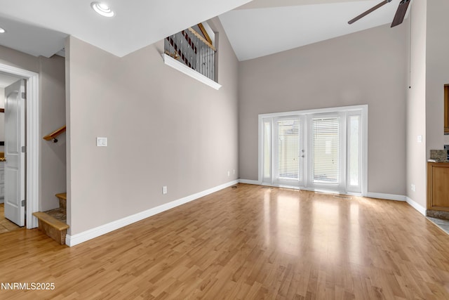 1220 Conway Ln, Reno, NV 89503 - empty room featuring stairs, ceiling fan, a high ceiling, light wood finished floors, and recessed lighting