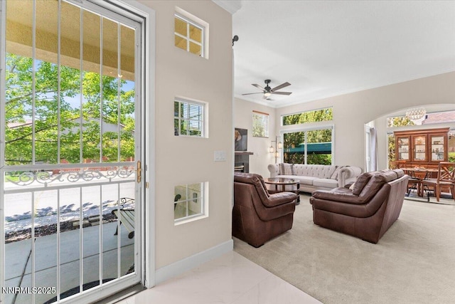 1328 Windridge Dr, Carson City, NV 89706 - living room with arched walkways, ornamental molding, a ceiling fan, baseboards, and a chandelier