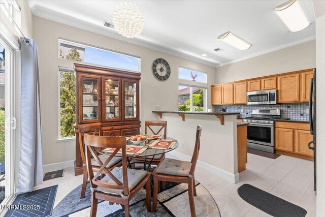 1328 Windridge Dr, Carson City, NV 89706 - dining space with crown molding, baseboards, and a chandelier