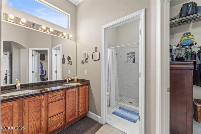 1328 Windridge Dr, Carson City, NV 89706 - bathroom with a stall shower, a spacious closet, double vanity, and marble look tiles