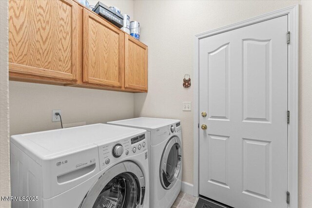 1328 Windridge Dr, Carson City, NV 89706 - laundry room featuring cabinet space, washer and dryer, light tile patterned floors, and baseboards