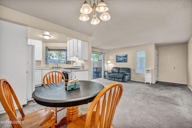 2511 Sycamore Glen Dr Apt 4, Sparks, NV 89434 - dining area featuring a chandelier, a textured ceiling, light carpet, and baseboards