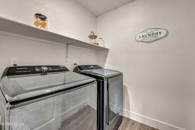 7939 Taconite Dr, Sparks, NV 89436 - laundry area with washing machine and dryer, wood finished floors, baseboards, and a textured wall