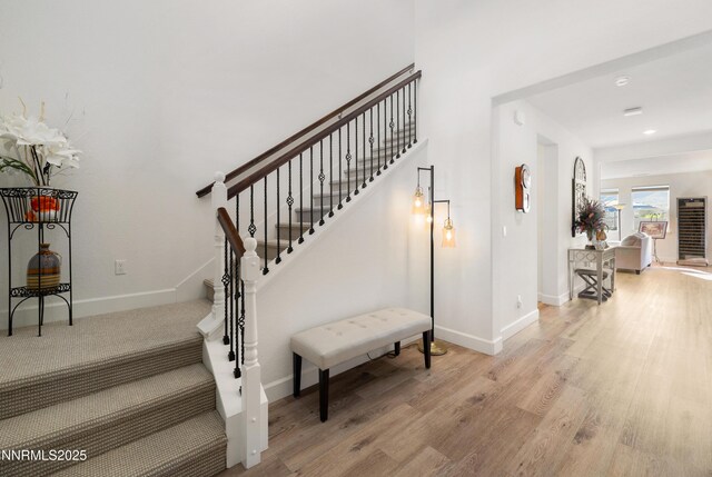 10260 Rollins Dr, Reno, NV 89521 - stairway with baseboards, wood finished floors, and recessed lighting