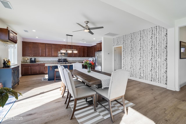 10260 Rollins Dr, Reno, NV 89521 - dining space with a ceiling fan, light wood-style flooring, baseboards, recessed lighting, and wallpapered walls
