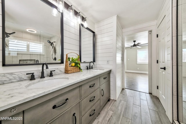 772 Mammoth Way, Gardnerville, NV 89460 - bathroom featuring double vanity, wood finished floors, ceiling fan, a tile shower, and baseboards
