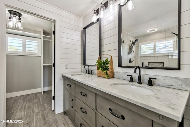 772 Mammoth Way, Gardnerville, NV 89460 - bathroom with double vanity, wood finished floors, a tile shower, and baseboards