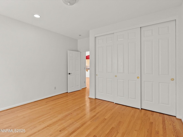 4943 Foxcreek Trl, Reno, NV 89519 - unfurnished bedroom with light wood finished floors, a closet, baseboards, and recessed lighting