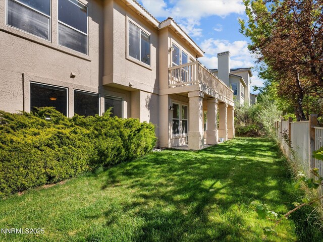 4943 Foxcreek Trl, Reno, NV 89519 - rear view of house featuring stucco siding and a balcony