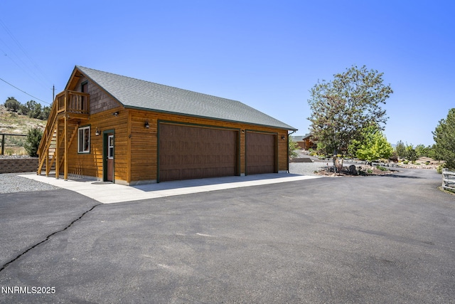 2607 Bowers Rd, Gardnerville, NV 89410 - view of side of home featuring a garage, stairs, and a shingled roof