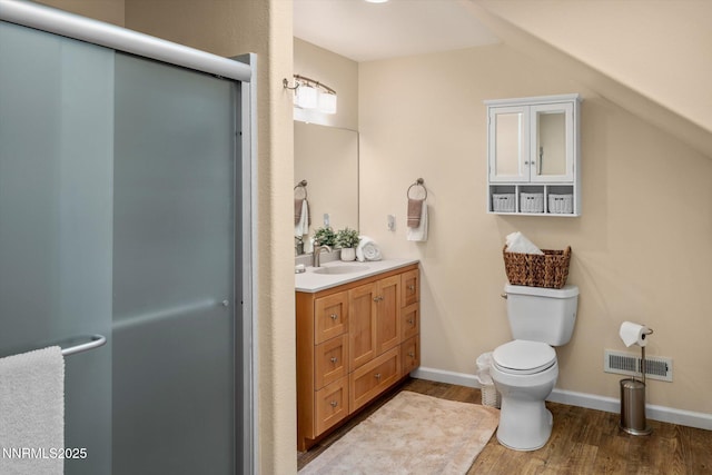 2607 Bowers Rd, Gardnerville, NV 89410 - bathroom featuring vanity, wood finished floors, a stall shower, toilet, and baseboards