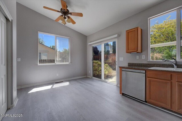 5737 Sonora Pass Dr, Sparks, NV 89436 - kitchen featuring stainless steel dishwasher, a sink, light wood finished floors, lofted ceiling, and brown cabinets