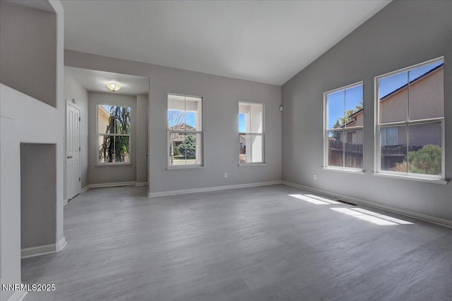 5737 Sonora Pass Dr, Sparks, NV 89436 - unfurnished living room with plenty of natural light, wood finished floors, baseboards, and vaulted ceiling