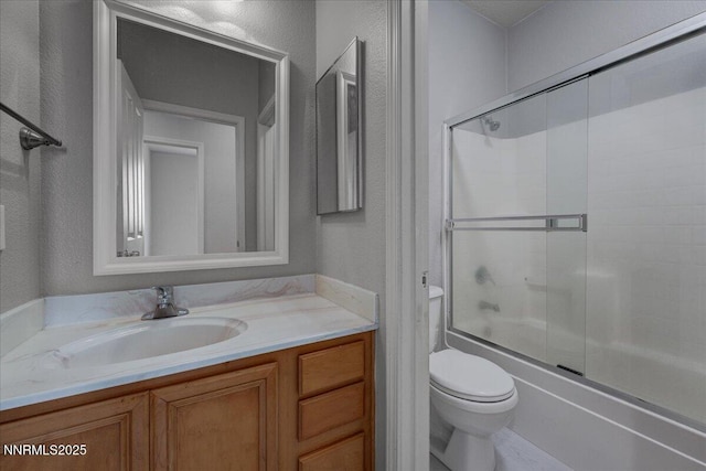 5737 Sonora Pass Dr, Sparks, NV 89436 - full bathroom with a textured wall, toilet, vanity, and bath / shower combo with glass door