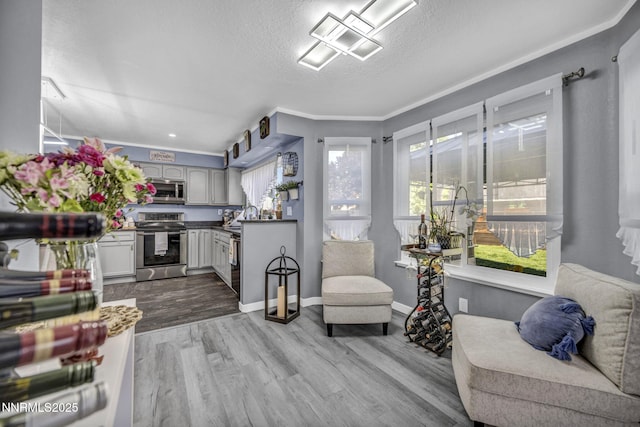 7395 Pah Rah Dr, Sparks, NV 89436 - sitting room with wood finished floors, ornamental molding, a textured ceiling, and baseboards