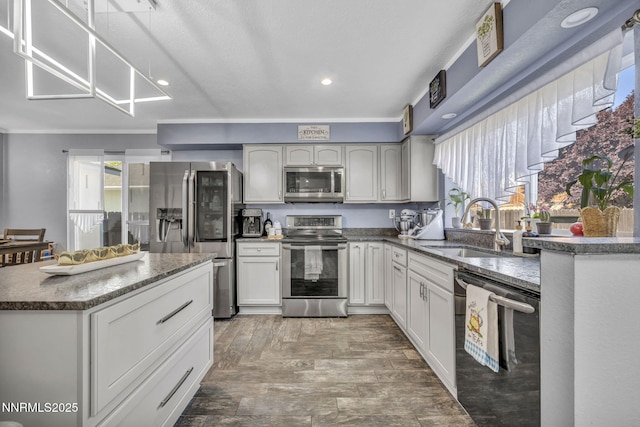 7395 Pah Rah Dr, Sparks, NV 89436 - kitchen featuring appliances with stainless steel finishes, a sink, wood finished floors, recessed lighting, and dark stone counters