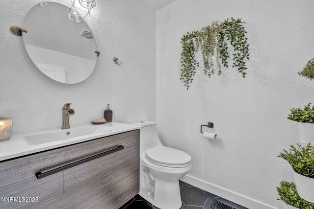 7395 Pah Rah Dr, Sparks, NV 89436 - bathroom with vanity, toilet, tile patterned floors, and baseboards