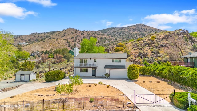 13820 Virginia Foothills Dr, Reno, NV 89521 - traditional-style home with a fenced front yard, driveway, an attached garage, a gate, and a mountain view
