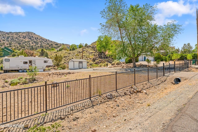 13820 Virginia Foothills Dr, Reno, NV 89521 - view of yard with a mountain view, driveway, and a garage