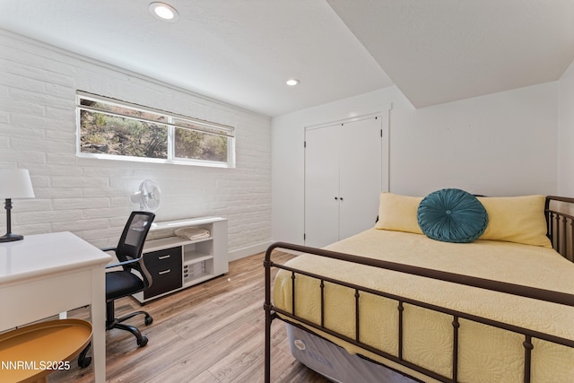 13820 Virginia Foothills Dr, Reno, NV 89521 - bedroom featuring light wood-type flooring, an office area, recessed lighting, and brick wall
