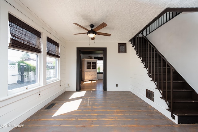1417 Douglas Ave, Gardnerville, NV 89410 - unfurnished living room featuring wood finished floors, healthy amount of natural light, ceiling fan, and stairway