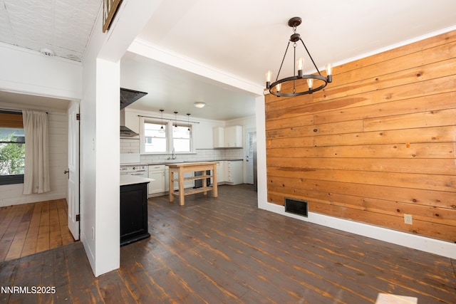 1417 Douglas Ave, Gardnerville, NV 89410 - kitchen with dark wood-type flooring, a sink, a chandelier, light countertops, and white cabinetry