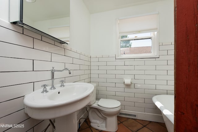 1417 Douglas Ave, Gardnerville, NV 89410 - bathroom featuring tile walls, a freestanding bath, tile patterned floors, and toilet