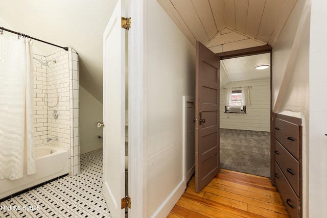 1417 Douglas Ave, Gardnerville, NV 89410 - bathroom featuring vaulted ceiling, shower / tub combo with curtain, and hardwood / wood-style floors