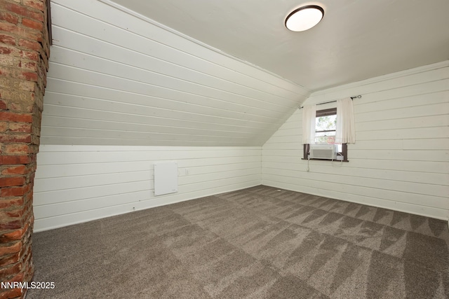 1417 Douglas Ave, Gardnerville, NV 89410 - additional living space with dark carpet, cooling unit, vaulted ceiling, and wooden walls