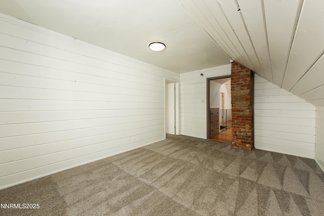 1417 Douglas Ave, Gardnerville, NV 89410 - unfurnished living room featuring carpet floors, vaulted ceiling, and wooden walls