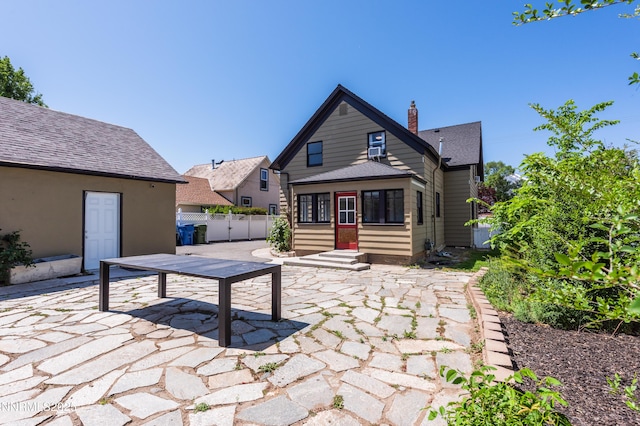 1417 Douglas Ave, Gardnerville, NV 89410 - back of house featuring a patio and a chimney