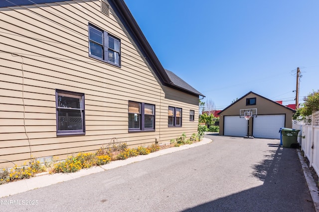 1417 Douglas Ave, Gardnerville, NV 89410 - view of side of home with a garage and an outdoor structure