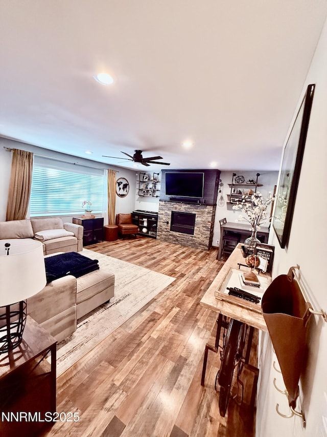 3100 Pine Ln, Carson City, NV 89706 - living room with a stone fireplace, a ceiling fan, wood finished floors, and recessed lighting