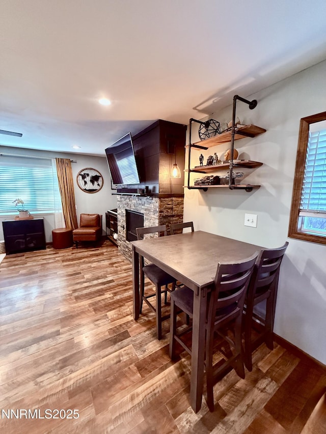 3100 Pine Ln, Carson City, NV 89706 - dining area featuring a fireplace, wood finished floors, and baseboards