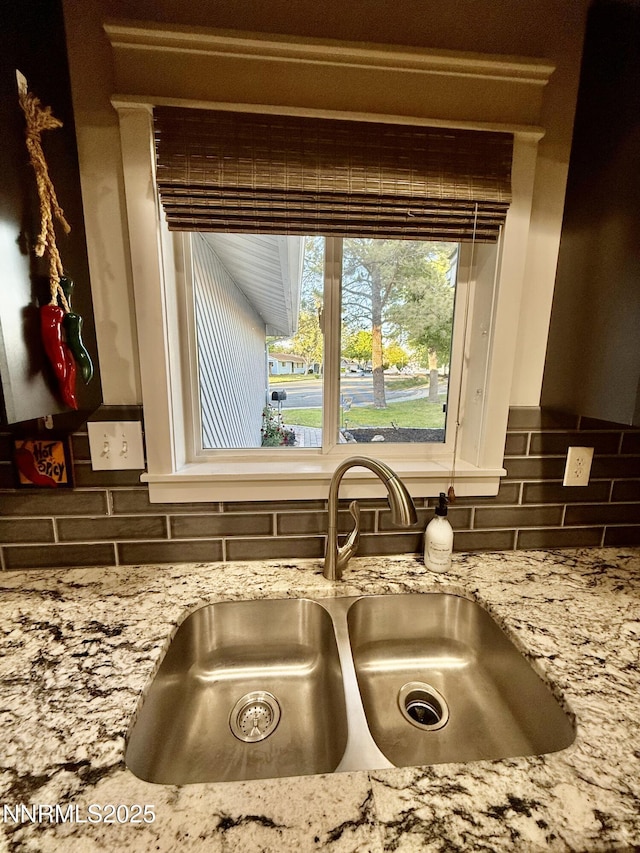 3100 Pine Ln, Carson City, NV 89706 - kitchen view of a sink, backsplash, and light stone counters