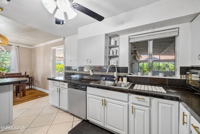 1712 Chaska Pl, Reno, NV 89502 - kitchen with stainless steel dishwasher, a sink, white cabinets, and ornamental molding